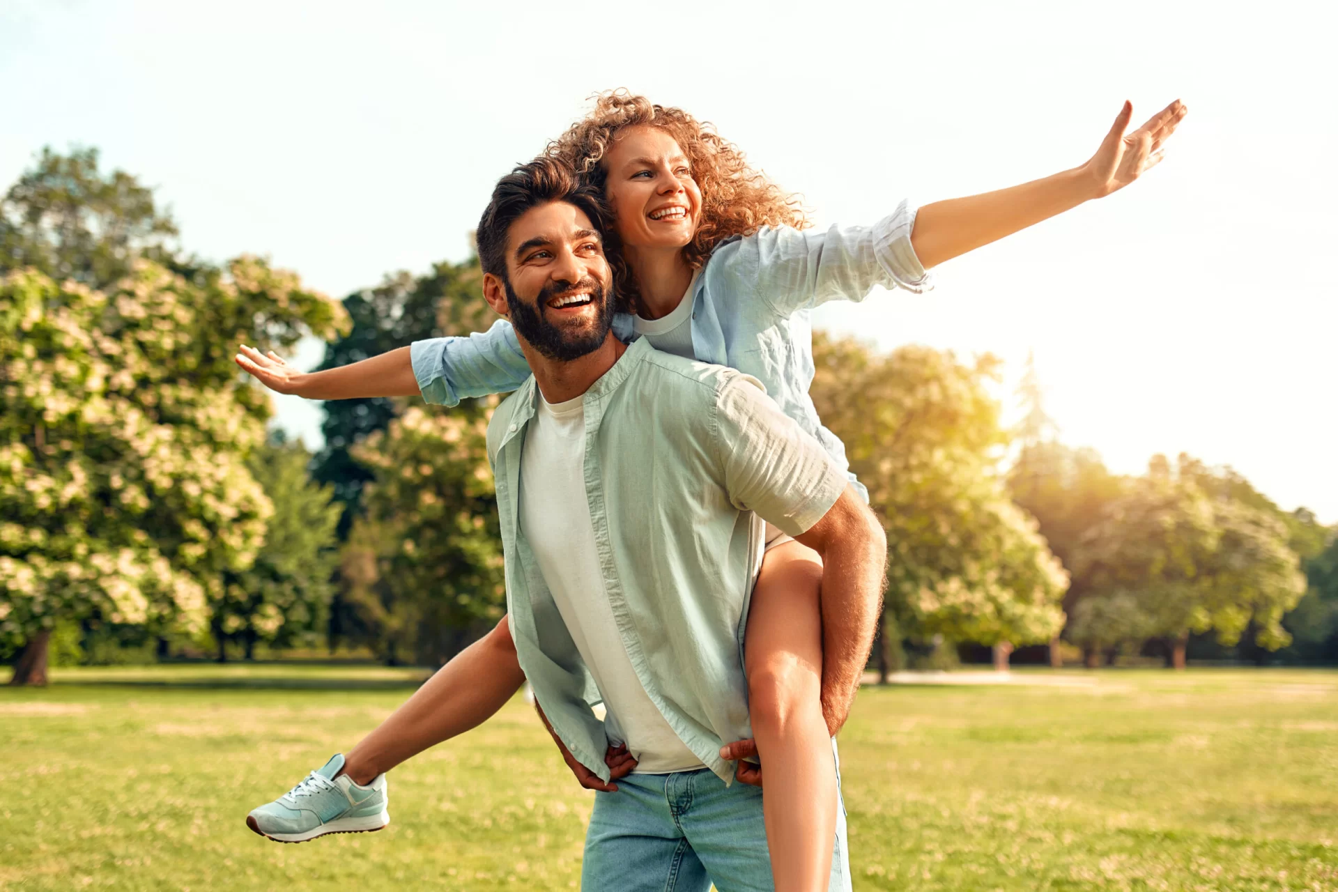 A happy couple enjoying a sunny day in the park