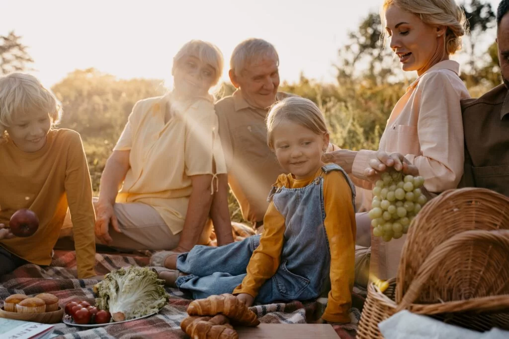 Three generations of a family enjoying a picnic